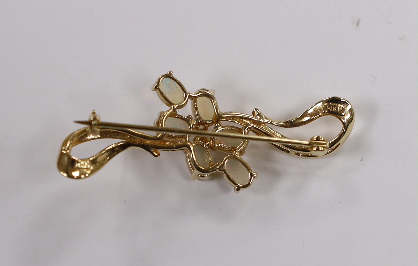 A 14k and six stone white opal cluster set brooch, 45mm, gross weight 5 grams.